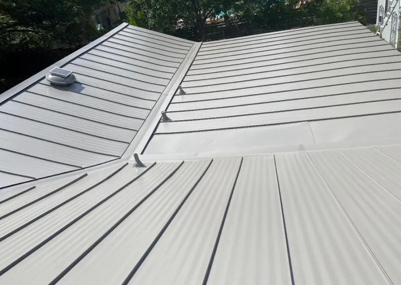 Solar attic fan installed on a metal roof for Roof Ventilation in Big Rapids